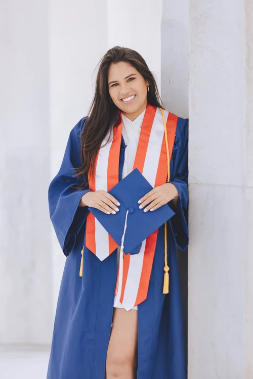 A graduate in blue academic regalia