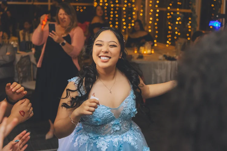 A candid portrait of a guest dancing at a celebration