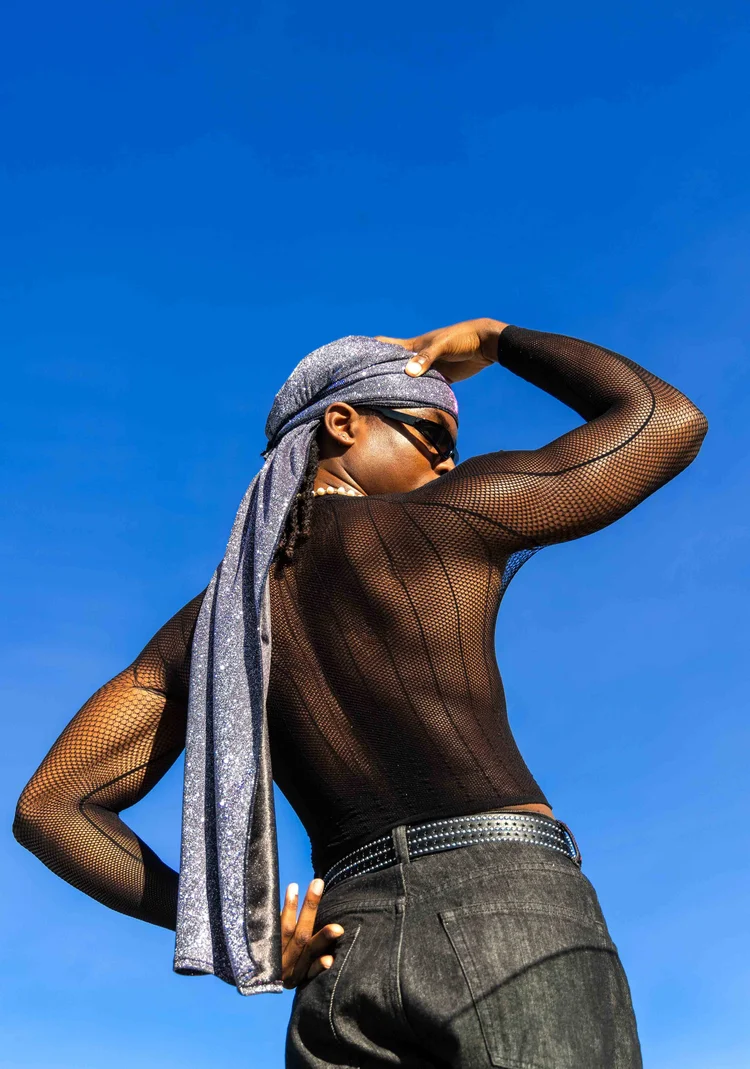 A bold fashion portrait against an open blue sky