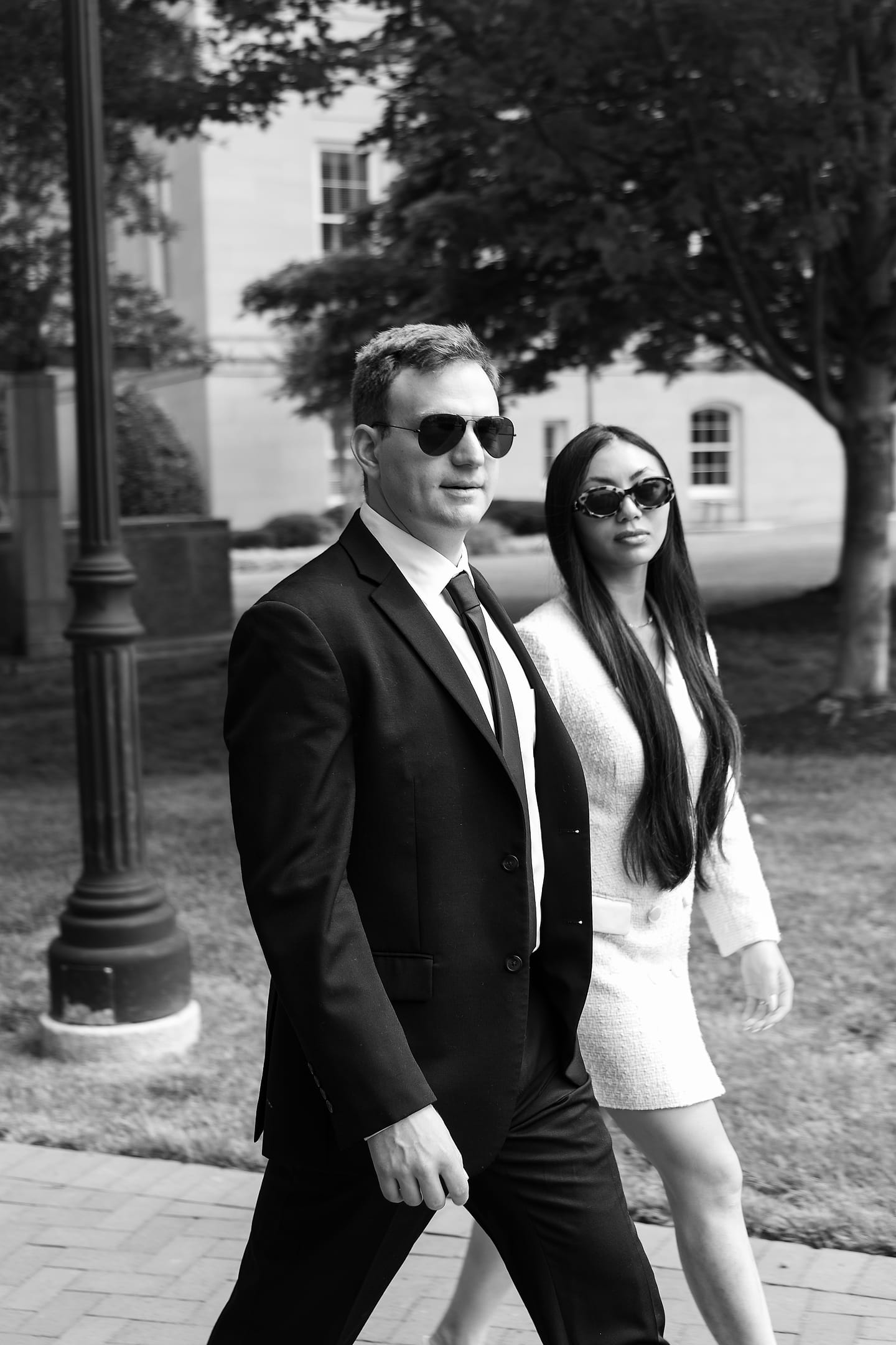 Black-and-white portrait of Jasmine and Aaron walking through downtown Washington DC
