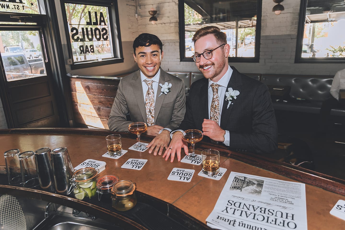 Marco and Nick toast with cocktails at the All Souls bar counter in Washington, D.C.