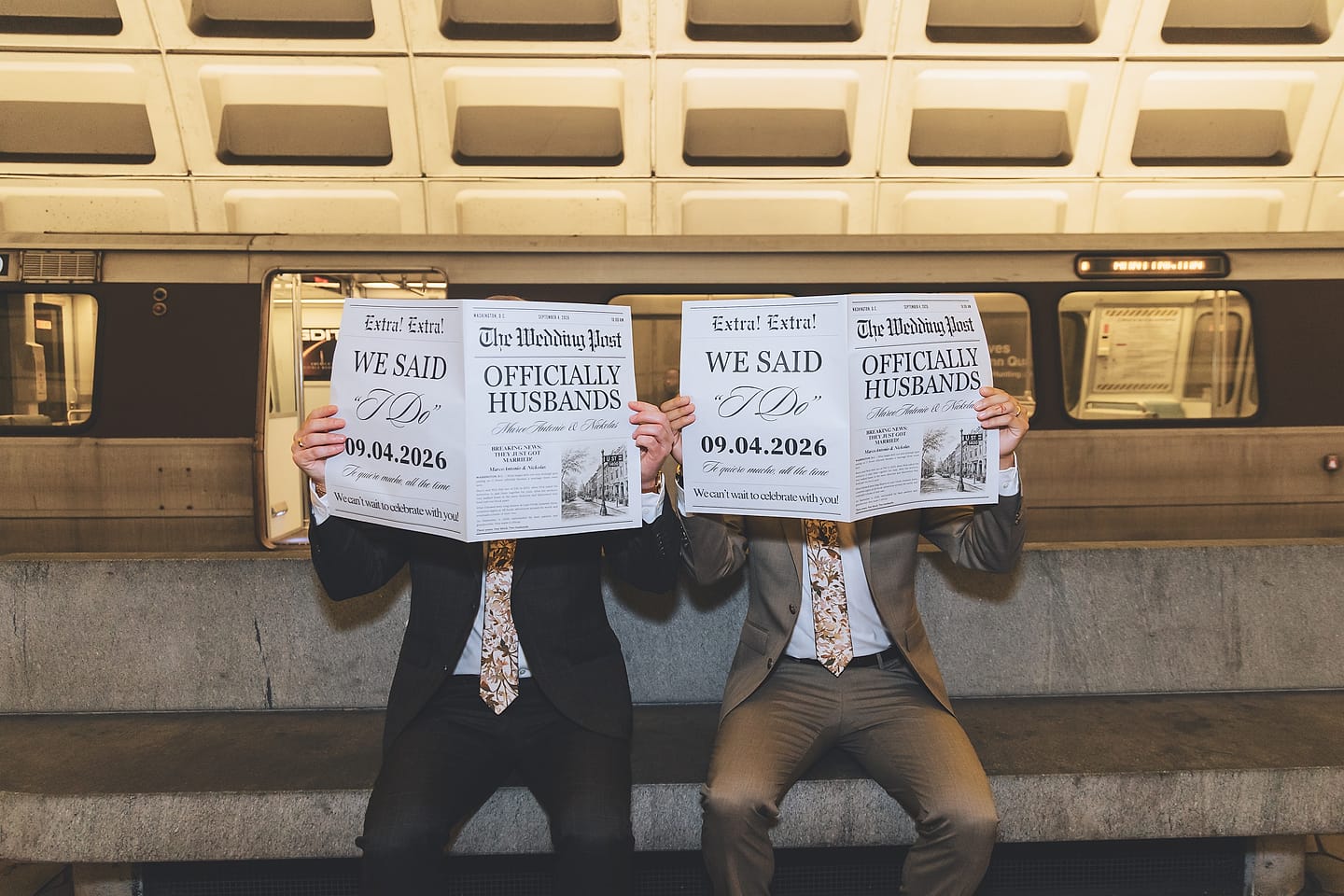 The two grooms hide behind matching 'We Said I Do' wedding newspapers on a Washington, D.C. Metro bench