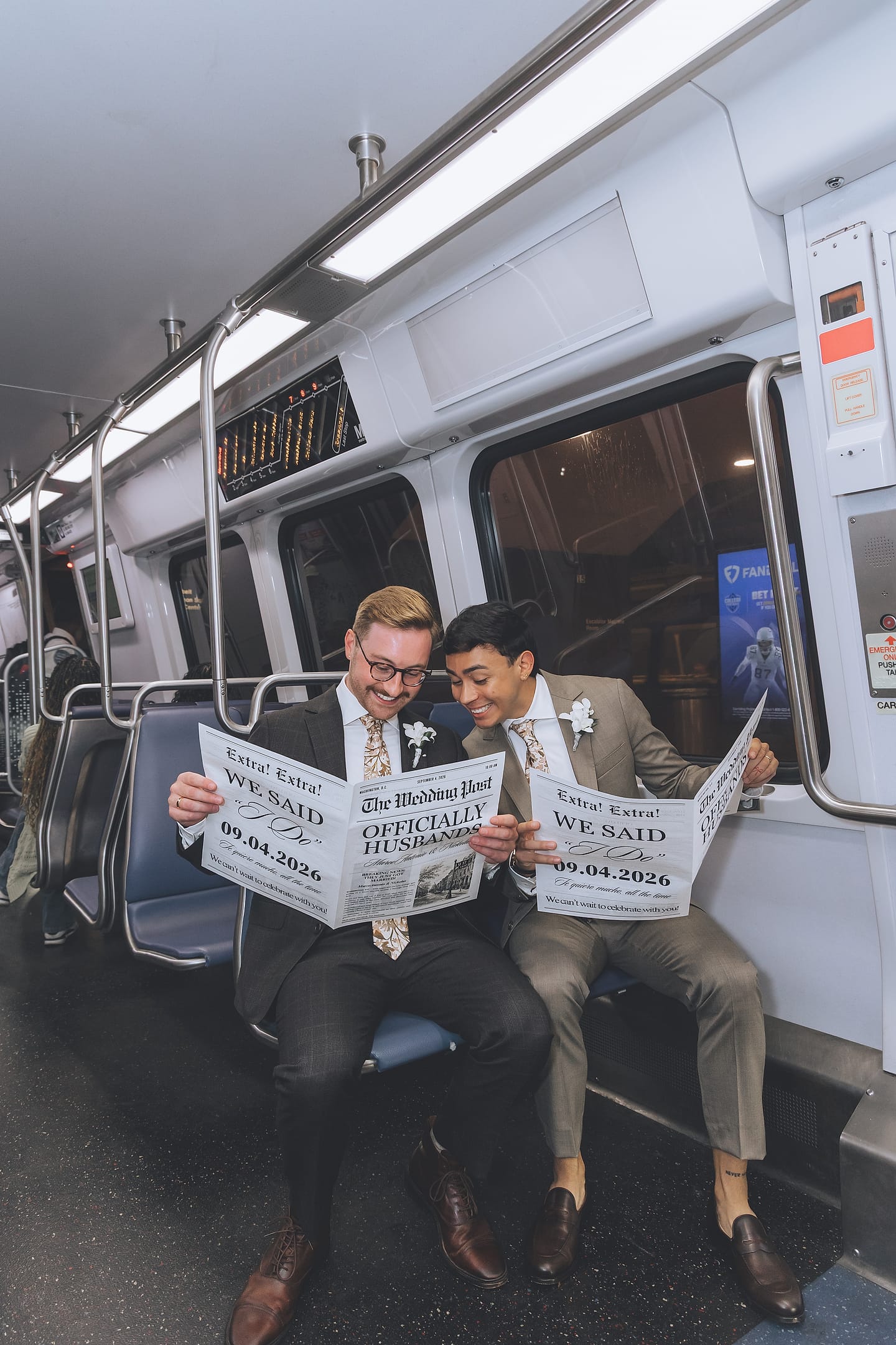 Marco and Nick read their custom 'We Said I Do' wedding newspapers side by side on the Washington, D.C. Metro
