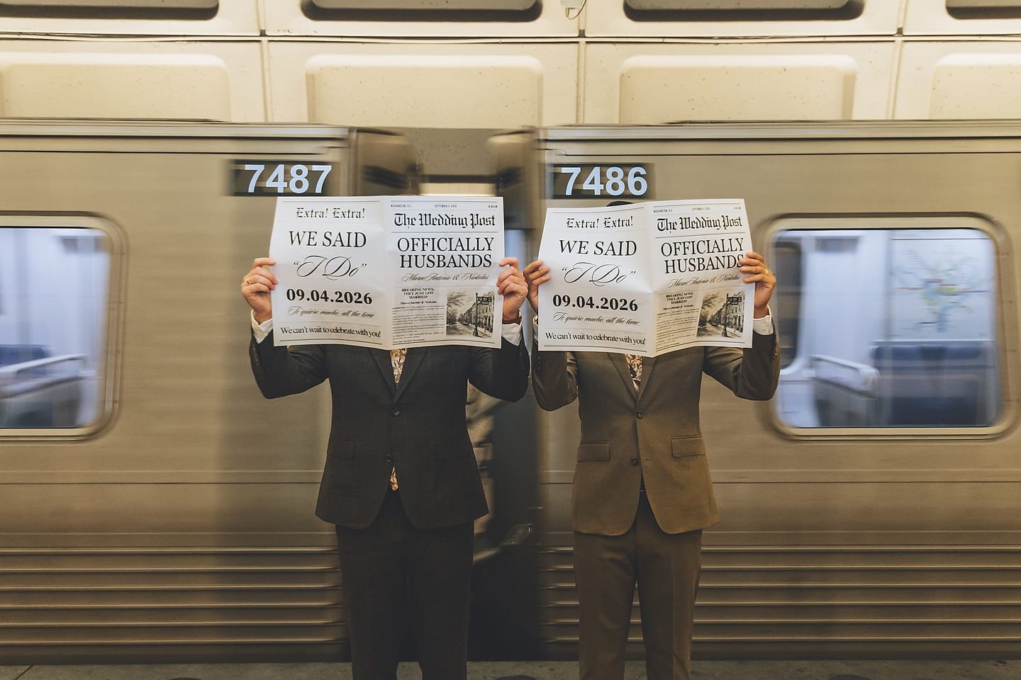 The two grooms hold up 'We Said I Do' and 'Officially Husbands' newspapers in front of a Washington, D.C. Metro train