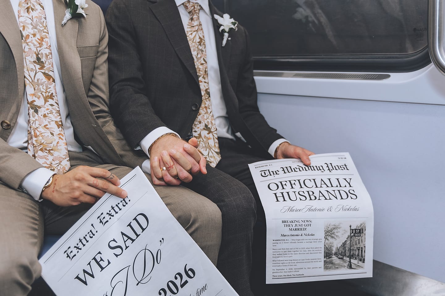 Marco and Nick hold hands on the Washington, D.C. Metro, one groom holding an 'Officially Husbands' wedding newspaper
