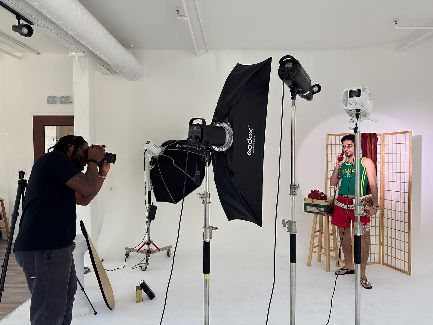 Trevaughn Smith photographing a client in his studio with softbox lighting
