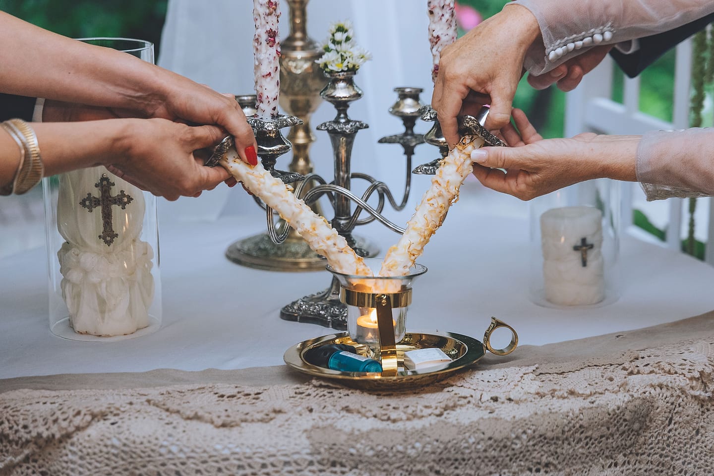 Loved ones light a unity candle during a wedding ceremony